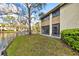 Beautiful home exterior with a pond view, screened in porch, and mature landscaping at 4154 Pinelake Ln # 101, Tampa, FL 33618