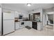 Bright kitchen features white appliances, wood countertops, tile backsplash, and a window overlooking the backyard at 4154 Pinelake Ln # 101, Tampa, FL 33618