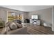 Bright living room with waterfront views, wood floors, and a modern entertainment center at 4154 Pinelake Ln # 101, Tampa, FL 33618