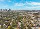 Scenic aerial shot showcasing a residential neighborhood with mature trees and cityscape in the distance beneath a partly cloudy blue sky at 832 13Th N Ave, St Petersburg, FL 33701