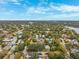 Sprawling neighborhood aerial showcasing rooftops, tree canopies and a distant lake at 832 13Th N Ave, St Petersburg, FL 33701