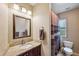 Cozy bathroom with a wooden vanity, granite counters and tiled shower at 832 13Th N Ave, St Petersburg, FL 33701