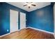 Blue Bedroom featuring hardwood floors and two closets at 832 13Th N Ave, St Petersburg, FL 33701