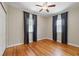 Bedroom featuring hardwood floors, large windows, and decorative curtains at 832 13Th N Ave, St Petersburg, FL 33701