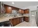 Modern kitchen with stainless steel appliances, granite countertops, stylish backsplash, and wood cabinetry at 832 13Th N Ave, St Petersburg, FL 33701