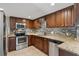 Updated kitchen featuring stainless steel appliances, granite countertops, tile backsplash, and wood cabinetry at 832 13Th N Ave, St Petersburg, FL 33701