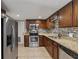 Well-lit kitchen featuring stainless steel appliances, granite countertops, tile backsplash, and wood cabinets at 832 13Th N Ave, St Petersburg, FL 33701