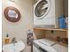 Convenient laundry area featuring stacked washer and dryer with mounted wooden mirror at 832 13Th N Ave, St Petersburg, FL 33701