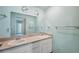 Bright bathroom featuring double sinks, a large mirror and ample counter space at 13000 Club Dr, Hudson, FL 34667
