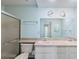 Bathroom featuring double sinks, vanity, and shower with glass door at 13000 Club Dr, Hudson, FL 34667