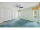 Well-lit bedroom featuring spacious closets, a ceiling fan, and cozy carpet at 13000 Club Dr, Hudson, FL 34667