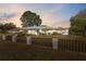 Exterior shot of home with yard as dusk settles around the neighborhood at 13000 Club Dr, Hudson, FL 34667
