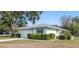 Charming home exterior featuring well-maintained landscaping and attached two-car garage at 13000 Club Dr, Hudson, FL 34667