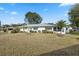 Charming home with well-kept lawn featuring manicured greenery at 13000 Club Dr, Hudson, FL 34667