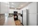 Well-lit kitchen featuring white cabinets, modern appliances, and tile floors at 13000 Club Dr, Hudson, FL 34667