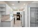 Bright kitchen featuring white cabinets and appliances, stainless sink, and ample counter space at 13000 Club Dr, Hudson, FL 34667