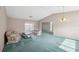Open living room showcasing neutral walls, vaulted ceiling, and sliding glass doors at 13000 Club Dr, Hudson, FL 34667