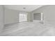 Spacious living room featuring updated flooring and neutral-color walls at 13000 Club Dr, Hudson, FL 34667