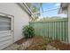Outdoor space featuring white door and a green fence at 13000 Club Dr, Hudson, FL 34667