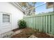 Enclosed outdoor space featuring white door and a green fence at 13000 Club Dr, Hudson, FL 34667