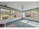 Bright sunroom with views of the backyard and mature landscaping at 13000 Club Dr, Hudson, FL 34667