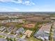 Aerial view of neighborhood featuring homes, trees, and a beautiful blue sky with some clouds at 30715 Tumbleberry St, Wesley Chapel, FL 33543