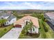 Aerial view of a home featuring a tile roof, brick driveway, and verdant landscaping at 30715 Tumbleberry St, Wesley Chapel, FL 33543