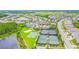 Aerial view of community amenities with tennis courts and pools, showcasing recreational options available to residents at 30715 Tumbleberry St, Wesley Chapel, FL 33543