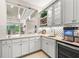 Stylish bar area with white cabinets, quartz countertops, wine rack, and beverage center at 30715 Tumbleberry St, Wesley Chapel, FL 33543