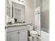 Neutral tone bathroom with granite vanity top, tile floors, and shower/tub combo at 30715 Tumbleberry St, Wesley Chapel, FL 33543