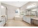 Bright bathroom featuring a soaking tub with tile surround, walk-in shower, and granite countertops at 30715 Tumbleberry St, Wesley Chapel, FL 33543