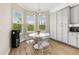 Bright breakfast nook with bay windows and custom built-in cabinetry at 30715 Tumbleberry St, Wesley Chapel, FL 33543