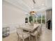 Formal dining room featuring elegant decor, tray ceiling, and natural light at 30715 Tumbleberry St, Wesley Chapel, FL 33543