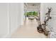 Inviting foyer with modern decorations and a view of the open living space and backyard at 30715 Tumbleberry St, Wesley Chapel, FL 33543