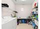 Spacious laundry room offers plenty of storage with wire racks and folding table at 30715 Tumbleberry St, Wesley Chapel, FL 33543