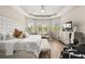 Bright and airy main bedroom suite with luxury vinyl flooring, tray ceilings and sitting area near bay windows at 30715 Tumbleberry St, Wesley Chapel, FL 33543