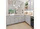 Wet bar area featuring white cabinets, a countertop, and built-in wine cooler and sink with open pass through at 30715 Tumbleberry St, Wesley Chapel, FL 33543