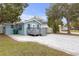 Charming light blue home with a cozy front porch and an inviting paved driveway at 5161 Rena N St, St Petersburg, FL 33709