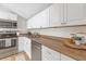 Efficient kitchen with stainless steel appliances, neutral countertop and white cabinets at 5161 Rena N St, St Petersburg, FL 33709