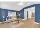 Cozy living room with hardwood floors, blue accent wall, and natural light at 5161 Rena N St, St Petersburg, FL 33709