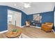 Bright living room with hardwood floors, blue accent wall, and comfortable seating at 5161 Rena N St, St Petersburg, FL 33709