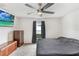 Cozy bedroom featuring a ceiling fan, neutral colors, and plush carpeting at 5403 Fez Ct, Brooksville, FL 34602