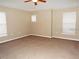 Spacious bedroom offers neutral paint, carpeting, and great natural light through the windows at 6769 Breezy Palm Dr, Riverview, FL 33578
