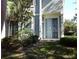 Exterior view of a patio area with sliding glass doors and pretty landscaping at 6769 Breezy Palm Dr, Riverview, FL 33578