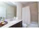 Bathroom with beige vanity, mirror, and shower over tub at 11125 Winthrop Lake Dr, Riverview, FL 33578