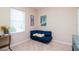 Bedroom with compact blue sofa, natural light, and modern wall decor at 11125 Winthrop Lake Dr, Riverview, FL 33578