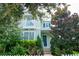 Charming light green two-story home with balcony and beautifully landscaped front yard at 11125 Winthrop Lake Dr, Riverview, FL 33578
