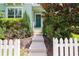 Inviting entryway with landscaped walkway and a white picket fence at 11125 Winthrop Lake Dr, Riverview, FL 33578
