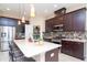 Stylish kitchen with granite countertops, stainless steel appliances, and a walk-in pantry at 11125 Winthrop Lake Dr, Riverview, FL 33578