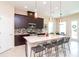 Modern kitchen with a large island, stainless steel appliances, and pendant lighting at 11125 Winthrop Lake Dr, Riverview, FL 33578